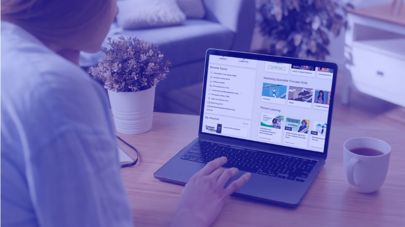 Person Browsing eLearning Topics and Courses on A Laptop in A Home Setting