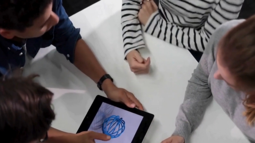 Three People Collaborate Around a Tablet