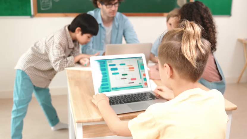 A Group of Children Working with Laptops in A Classroom, with One Child Using an Ai-Driven Tutoring System on Their Screen
