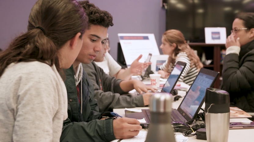 Students Collaborate on Laptops in A Study Session While Others Focus on Their Work in The Background