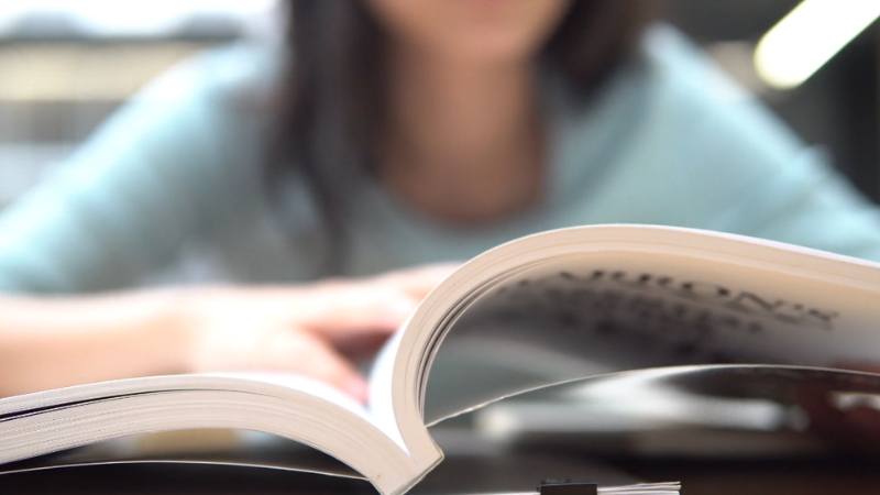 A person reading a book in a quiet and focused environment