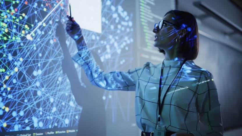 A Teacher Using a Projector to Explain Data Visualizations in A Classroom, Showing how Generative AI Is Integrated Into Teaching