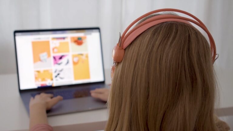 A student engaged in hybrid learning, using a laptop and headphones to participate in an online class