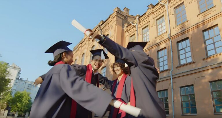 A group of graduates celebrates their achievement