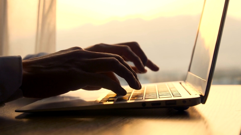 A Person Typing on A Laptop, Composing a Polite Reminder for A Letter of Recommendation