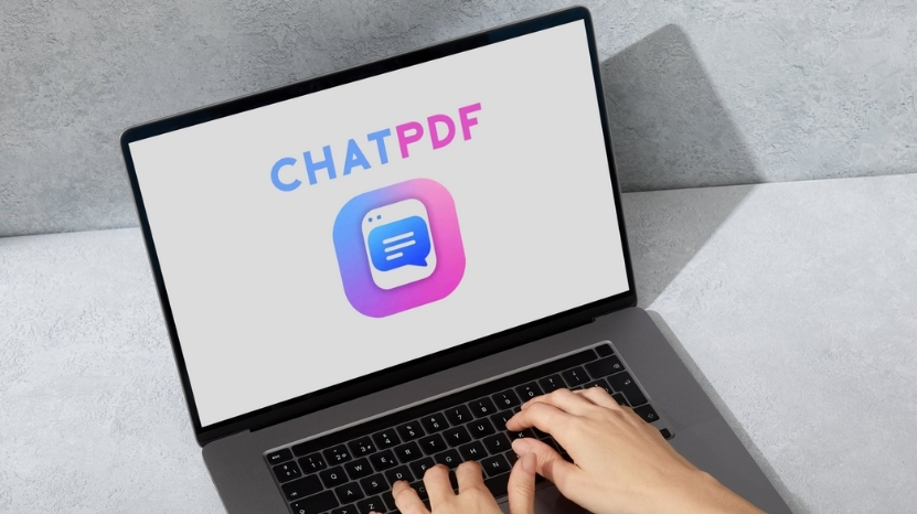 A person using a laptop with the ChatPDF app logo displayed on the screen