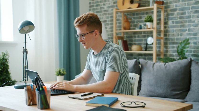 A student types on a laptop at home, showing how digital tools can support and track their work for classroom use