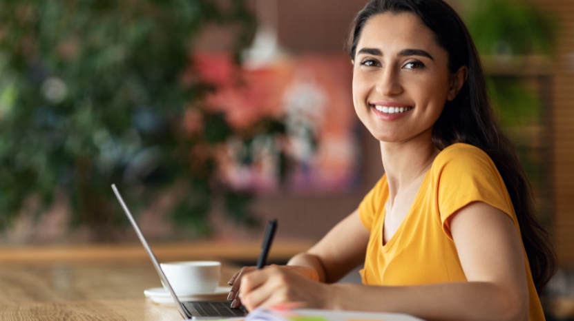 A student works on freelance projects at a laptop to gain work experience