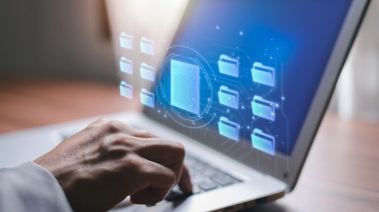 A person uses a laptop to explore folders and files in a digital learning management system interface