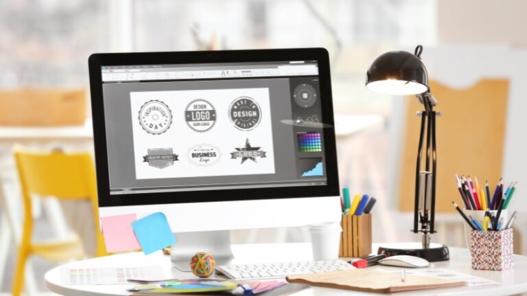 A computer screen shows a graphic designer creating logo designs